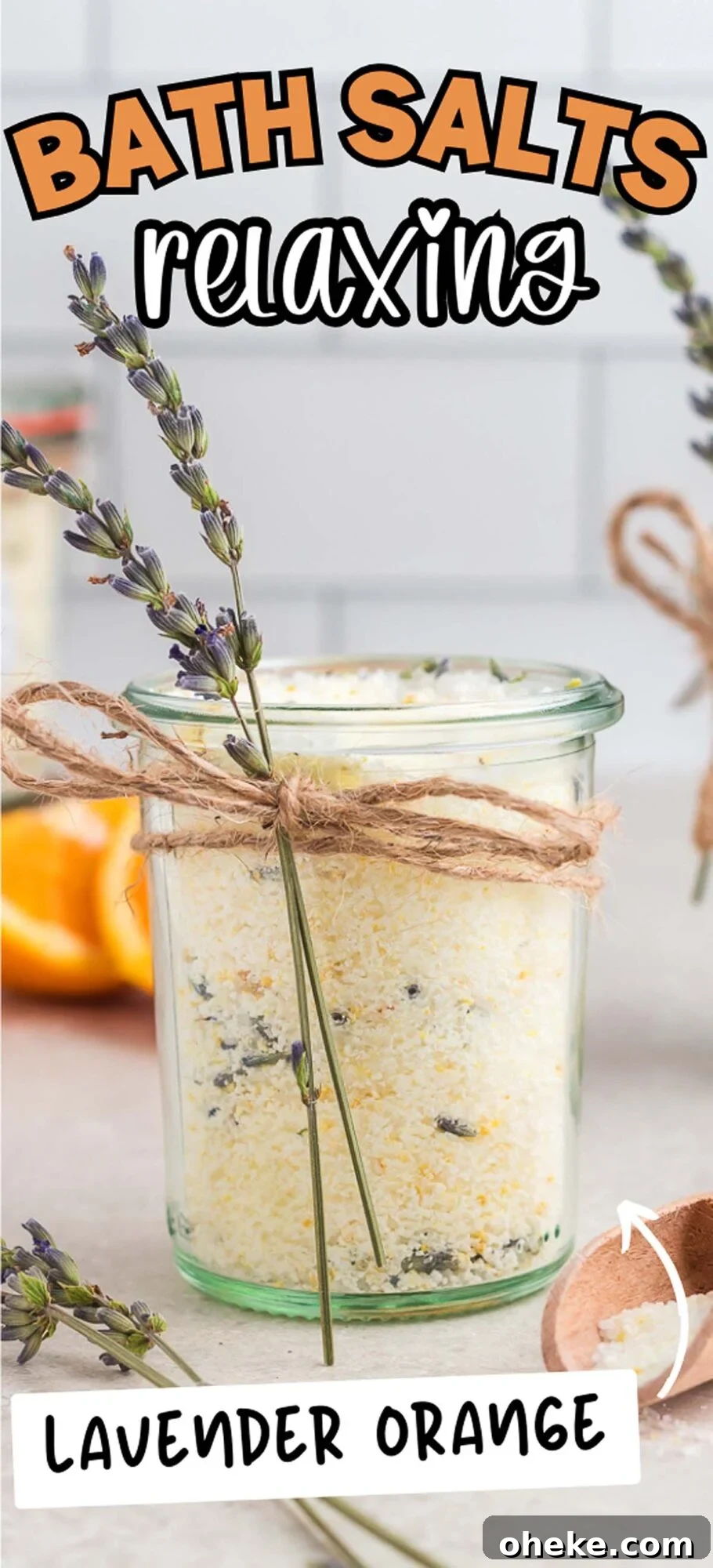 A glass jar of DIY Lavender Orange Bath Salts with dried lavender and a twine bow, labeled “relaxing.”.
