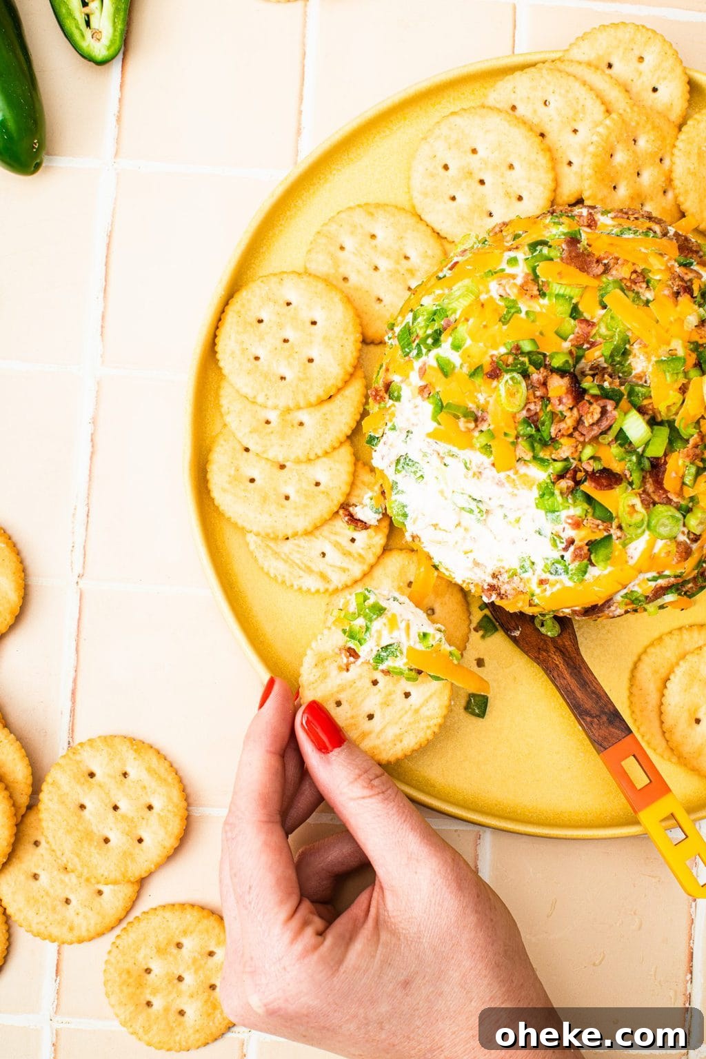 hand holding platter with cheese ball and crackers