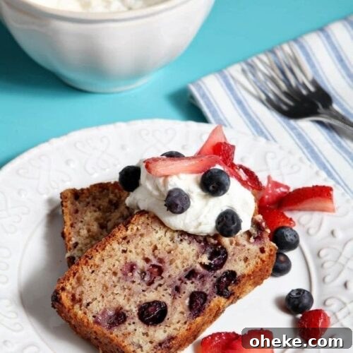 Two slices of berry pound cake with whipped cream and berries