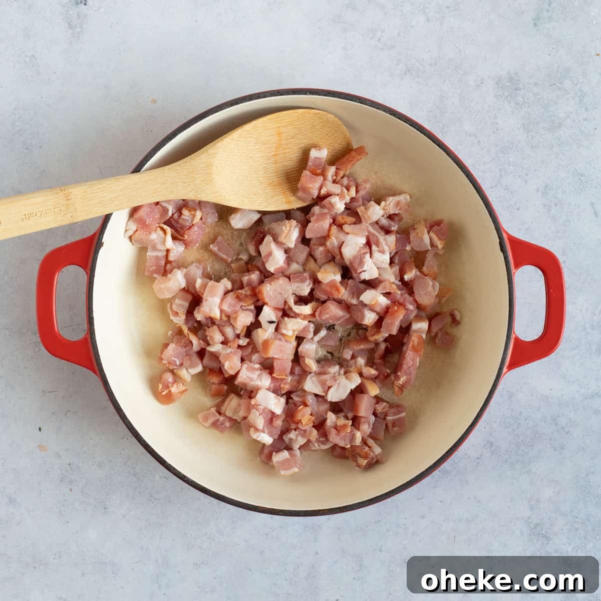 Bacon lardons frying in oil.