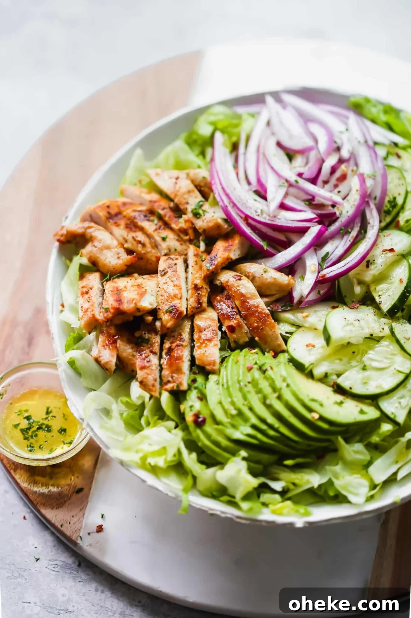 Grilled avocado chicken salad in a white bowl. 