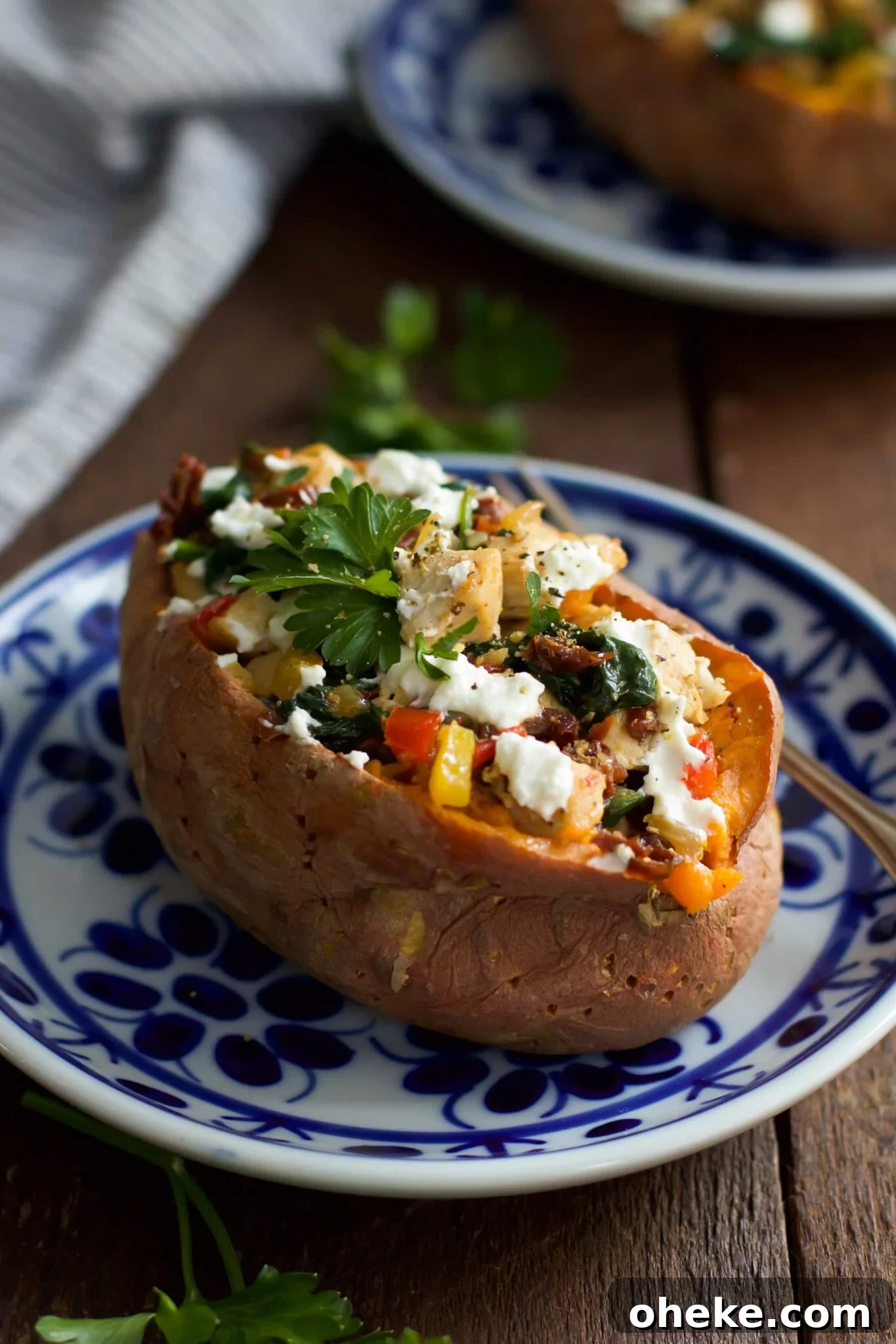 Goat cheese chicken stuffed sweet potato on a plate. 