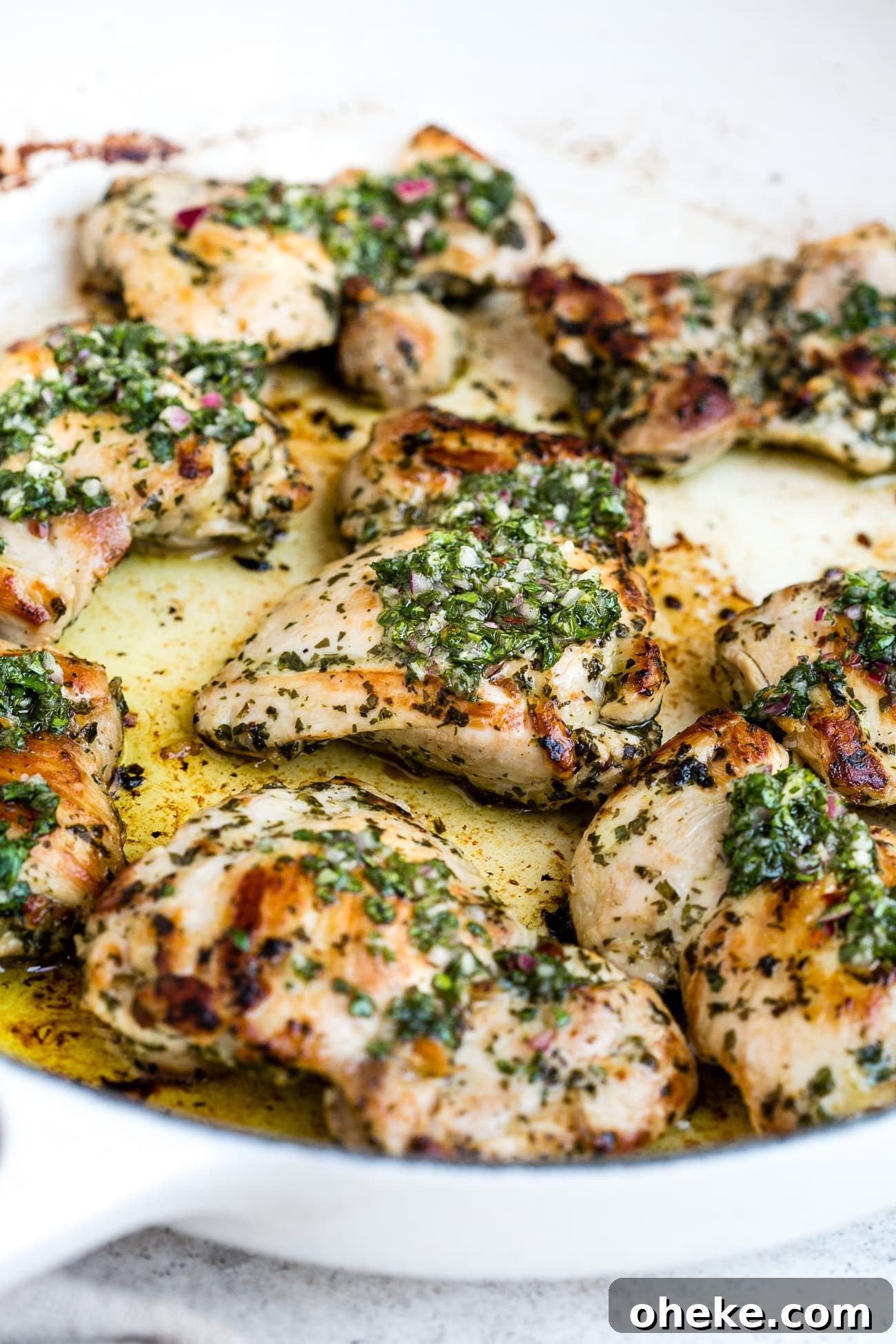 Chimichurri chicken in a large, white skillet.
