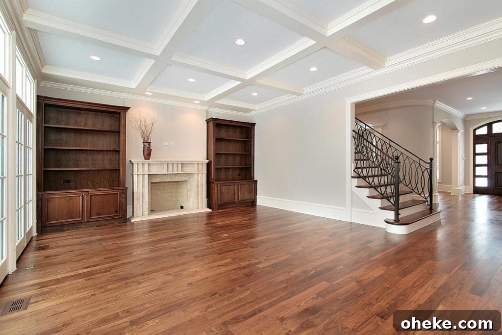 cherry hardwood floors in a large family room with built in bookcases and a fireplace