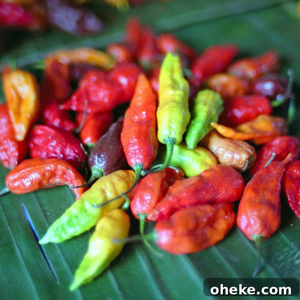 Several ghost peppers on a banana leaf.