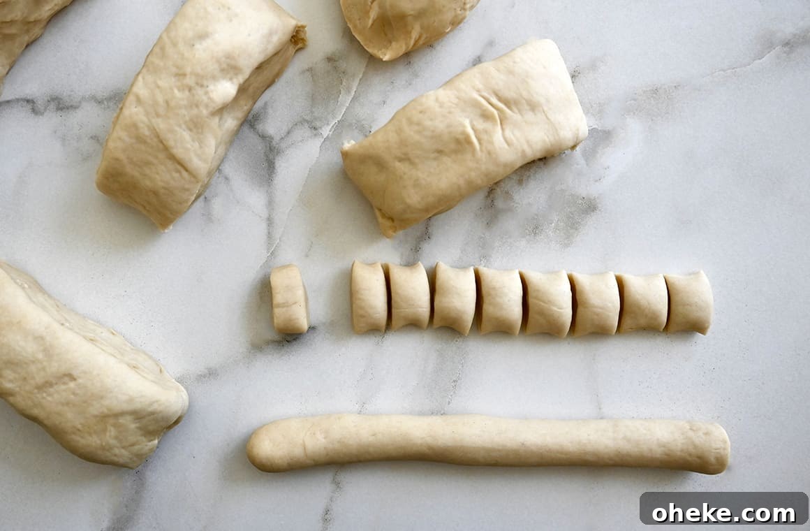 A top-down view of rolled dough next to more dough cut into small pieces