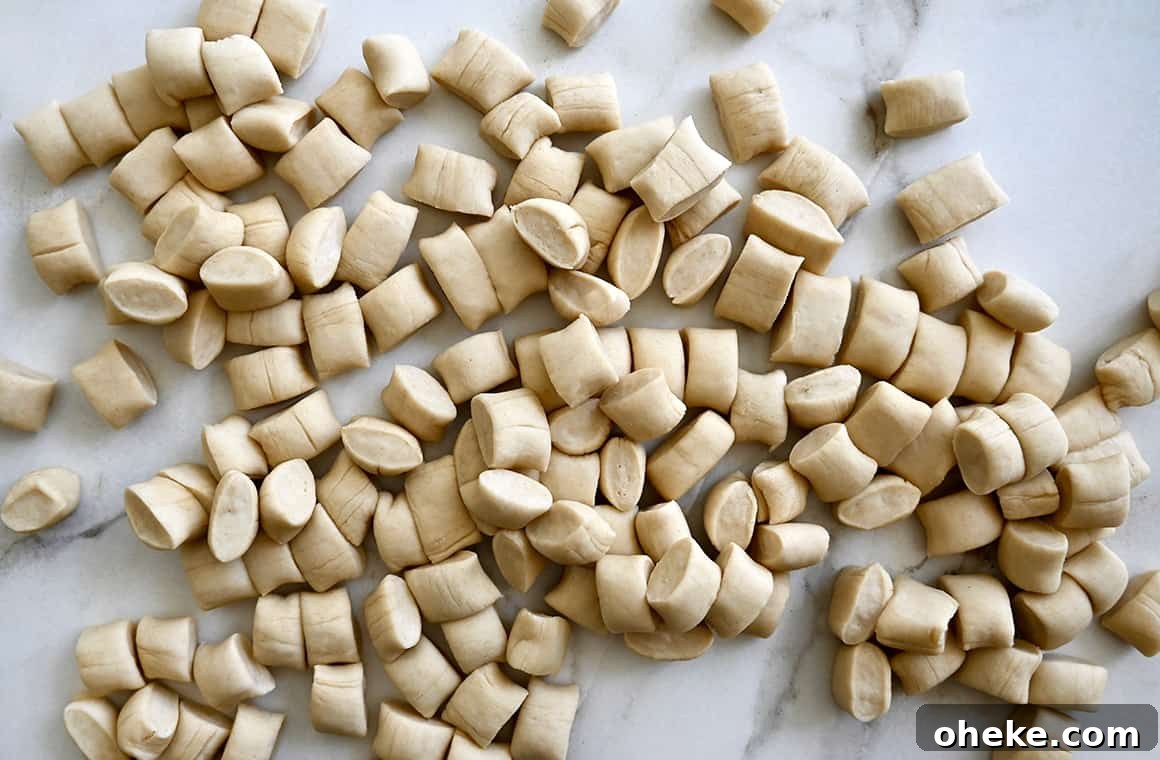 A top-down view of unbaked pieces of pretzel dough